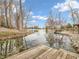 Picturesque lake view from the dock, showcasing the tranquil waters and the lush surroundings at 454 Roberson Blvd, Mooresville, IN 46158