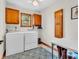 Bright laundry room with washer, dryer, cabinets, and a patterned rug at 454 Roberson Blvd, Mooresville, IN 46158