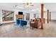 Open concept living room with a fireplace and large windows bringing the outdoors in at 454 Roberson Blvd, Mooresville, IN 46158