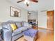Living room flowing to Primary bedroom with hardwood floors, neutral walls, and ceiling fan at 454 Roberson Blvd, Mooresville, IN 46158