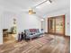 Spacious living room with hardwood floors and a sliding glass door to the backyard at 454 Roberson Blvd, Mooresville, IN 46158
