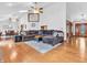 Bright living room featuring hardwood floors, plush sofa, and open layout at 454 Roberson Blvd, Mooresville, IN 46158