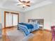 Serene main bedroom with hardwood floors, ceiling fan and a sliding door to the backyard at 454 Roberson Blvd, Mooresville, IN 46158