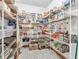 Well-stocked walk-in pantry with wire shelving, patterned floors, and ample storage space at 454 Roberson Blvd, Mooresville, IN 46158