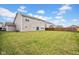 Large, green backyard with a wooden fence, perfect for outdoor activities and privacy at 5374 Marigold Dr, Plainfield, IN 46168