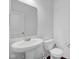 Classic half-bathroom with a white pedestal sink, toilet, and elegant fixtures at 5374 Marigold Dr, Plainfield, IN 46168