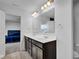 Bathroom with double sink vanity, large mirror, and stylish lighting fixture at 5374 Marigold Dr, Plainfield, IN 46168