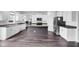 Modern kitchen with white cabinets, stainless steel appliances, and a dark island at 5374 Marigold Dr, Plainfield, IN 46168