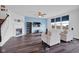 Bright living room with fireplace, dark floors, and a blue accent wall at 5374 Marigold Dr, Plainfield, IN 46168