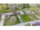 Aerial view of a landscaped front yard and a long driveway leading to a brick home at 5420 E 81St St, Indianapolis, IN 46250