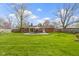 Expansive backyard featuring a well-manicured lawn, patio, and mature trees at 5420 E 81St St, Indianapolis, IN 46250