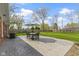 Landscaped backyard with stamped concrete patio, dining set and lush green lawn at 5420 E 81St St, Indianapolis, IN 46250