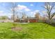 Beautifully landscaped backyard with large lawn, mature trees, and patio area at 5420 E 81St St, Indianapolis, IN 46250