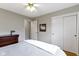 Cozy bedroom featuring a queen-size bed, closet with sliding doors, and a charming decor at 5420 E 81St St, Indianapolis, IN 46250
