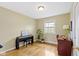 Well-lit bedroom featuring a piano, desk, and hardwood floors, creating a versatile and inviting space at 5420 E 81St St, Indianapolis, IN 46250
