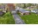 Aerial view of a charming brick home with an attached garage and manicured lawn at 5420 E 81St St, Indianapolis, IN 46250