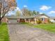 Beautiful brick home featuring an attached two-car garage, lush green lawn, and driveway at 5420 E 81St St, Indianapolis, IN 46250