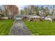 Aerial view of charming brick home with lush lawn and a long driveway at 5420 E 81St St, Indianapolis, IN 46250