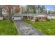 Aerial view showcases the front of a brick home, lush lawn, and a long driveway at 5420 E 81St St, Indianapolis, IN 46250