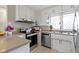 Classic kitchen features stainless steel appliances and white cabinets with diamond-paned windows at 5420 E 81St St, Indianapolis, IN 46250