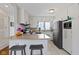 Bright kitchen features white cabinets, stainless steel appliances, a breakfast bar and tile floors at 5420 E 81St St, Indianapolis, IN 46250