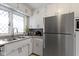 Kitchen features stainless appliances, diamond-paned windows, and white cabinets at 5420 E 81St St, Indianapolis, IN 46250