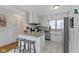 Kitchen features white cabinetry, stainless steel appliances, breakfast bar, and tile floors at 5420 E 81St St, Indianapolis, IN 46250