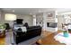 Open-concept living room with hardwood floors, a fireplace, and built-in bookshelves at 5420 E 81St St, Indianapolis, IN 46250