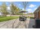 Outdoor patio with a table and chairs with umbrella with a view of the backyard at 5420 E 81St St, Indianapolis, IN 46250