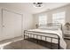 Bedroom with a wrought iron bed, white walls, and two windows allowing for lots of natural light at 564 N Beville Ave, Indianapolis, IN 46201