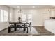 Dining room featuring a dark wood table, stylish lighting, and French doors to the backyard at 564 N Beville Ave, Indianapolis, IN 46201