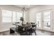 Bright dining area with modern lighting, a dark wood table, and seamless access to the outdoor space at 564 N Beville Ave, Indianapolis, IN 46201