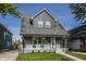 Charming renovated house with a gray exterior, inviting porch, and well-manicured lawn at 564 N Beville Ave, Indianapolis, IN 46201