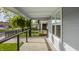Inviting front porch with a hanging fern, offering a relaxing outdoor space with views of the neighborhood at 564 N Beville Ave, Indianapolis, IN 46201