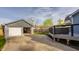 View of a detached garage with a wide driveway and space for parking and storage at 564 N Beville Ave, Indianapolis, IN 46201