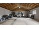 Spacious two car garage with open rafters offers plenty of room for storage and recreation at 564 N Beville Ave, Indianapolis, IN 46201