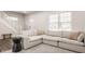 Bright living room featuring a large, comfortable sectional sofa, perfect for relaxation and entertaining at 564 N Beville Ave, Indianapolis, IN 46201