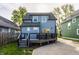 Home's rear exterior features an outdoor deck, backyard, and access to driveway at 564 N Beville Ave, Indianapolis, IN 46201
