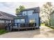 Home's rear exterior features an outdoor deck and access to driveway at 564 N Beville Ave, Indianapolis, IN 46201