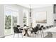 Bright dining area with modern light fixture and seating for eight near large windows at 5721 Palazzo Ln, McCordsville, IN 46055