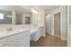 Bathroom with dual sinks, white cabinetry, and a large mirror with modern lighting at 5804 Summertree Pl, Whitestown, IN 46052