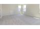 Bright carpeted bedroom with a neutral color palette, white trim, and two large windows at 5804 Summertree Pl, Whitestown, IN 46052