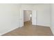 A bright bedroom featuring hardwood floors, white trim, and entry to more of the home beyond double doors at 5804 Summertree Pl, Whitestown, IN 46052