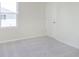 Well-lit carpeted bedroom with a window and a door, offering a serene and inviting space at 5804 Summertree Pl, Whitestown, IN 46052