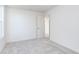 Bright bedroom with neutral carpet, white walls, and an open doorway at 5804 Summertree Pl, Whitestown, IN 46052