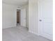 Neutral bedroom with plush carpeting, featuring a closet and white doors at 5804 Summertree Pl, Whitestown, IN 46052
