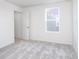 Neutral bedroom with cozy carpet, natural light and a view of the outdoor area for a peaceful retreat at 5804 Summertree Pl, Whitestown, IN 46052