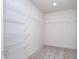 Walk-in closet with ample shelving for organized storage, maximizing space and convenience at 5804 Summertree Pl, Whitestown, IN 46052
