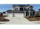 Charming two-story home featuring a three-car garage and modern gray and black exterior at 5804 Summertree Pl, Whitestown, IN 46052
