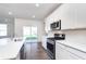 Modern kitchen featuring white cabinets, stainless steel appliances, and a large island at 5804 Summertree Pl, Whitestown, IN 46052
